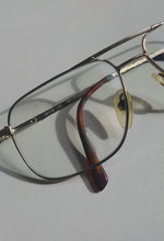 Load and play video in Gallery viewer, 1980s Bulova Blue Light Gold Frame Glasses
